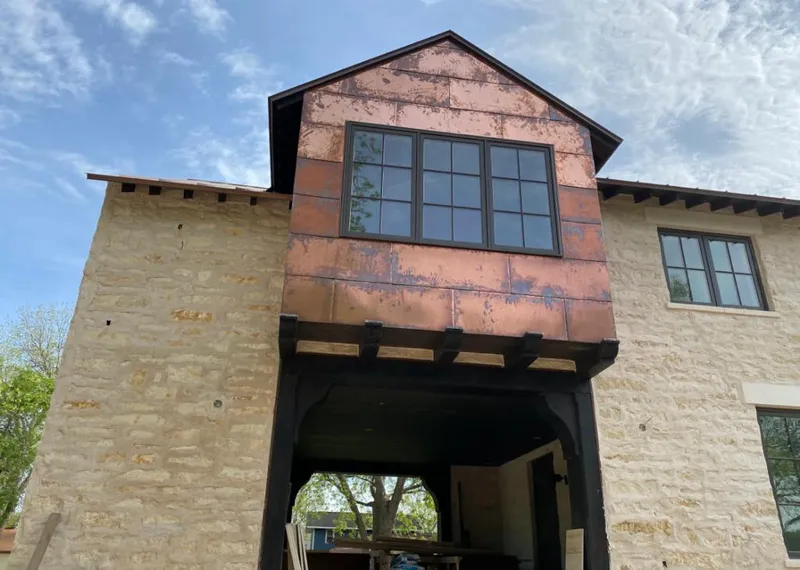 Copper metal panel facade on a stone building for Skylight Installation in Clewiston