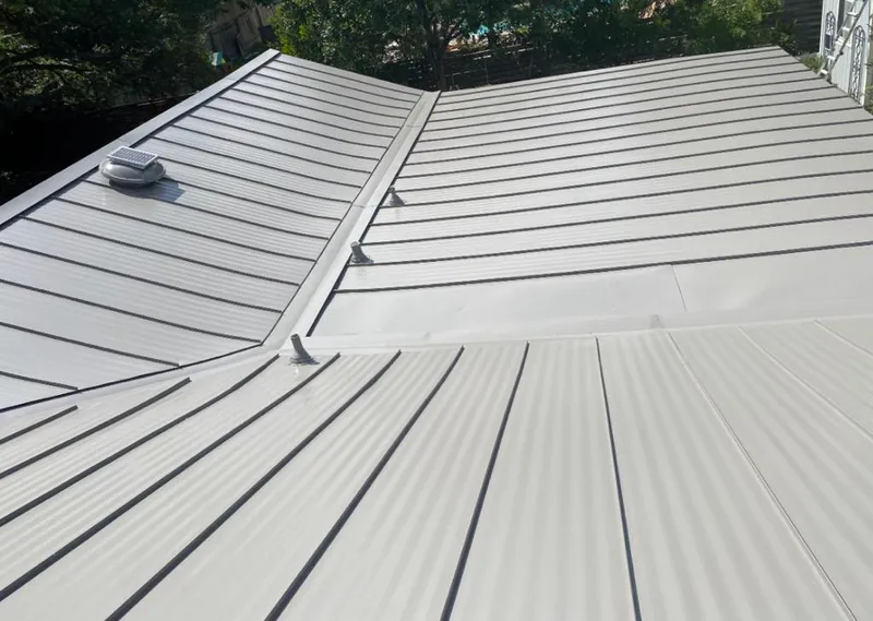 Solar attic fan installed on a metal roof for Roof Ventilation in Clewiston